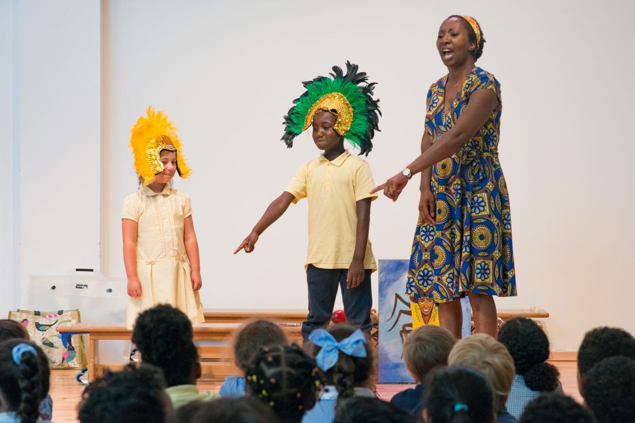 Wendy is mid-flow, telling a story with the help of two children in costume.