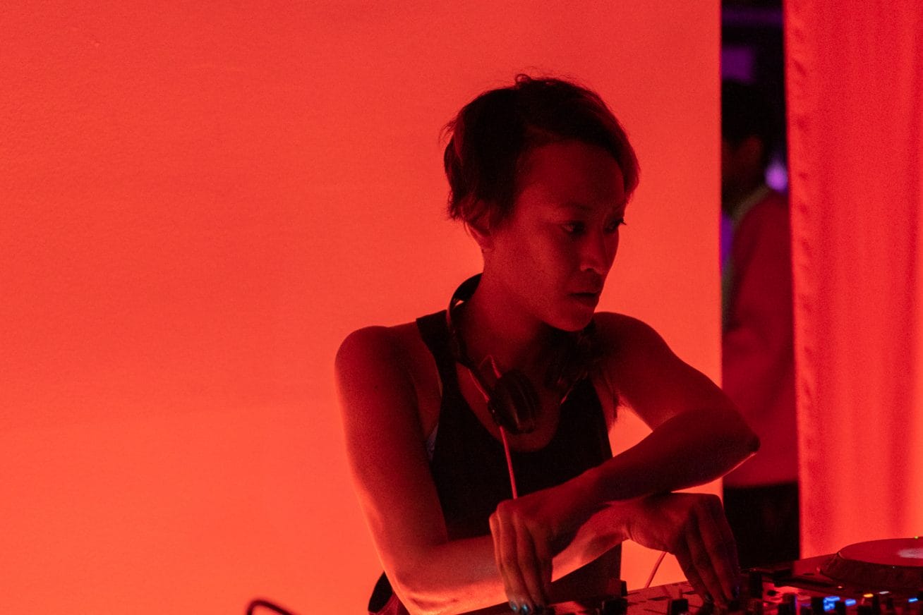 DJ illuminated by orange light