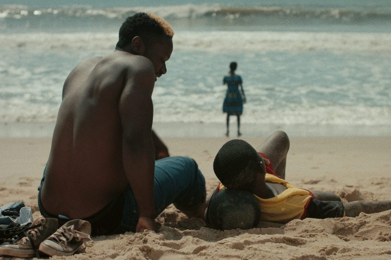 A man and his son sat on the beach